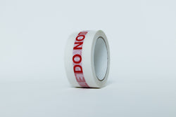 Roll of tape with 'DO NOT' text on a white background