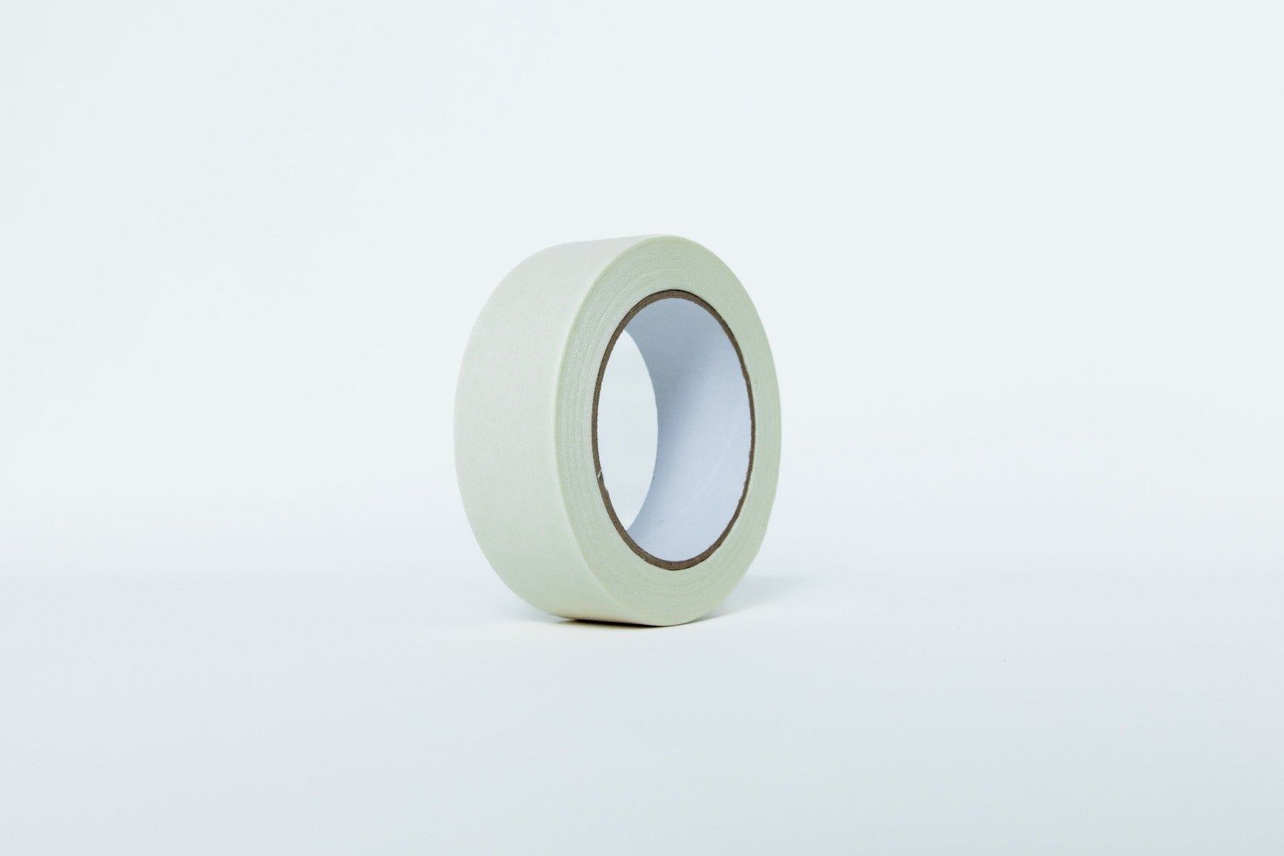 Roll of green tape on a white background