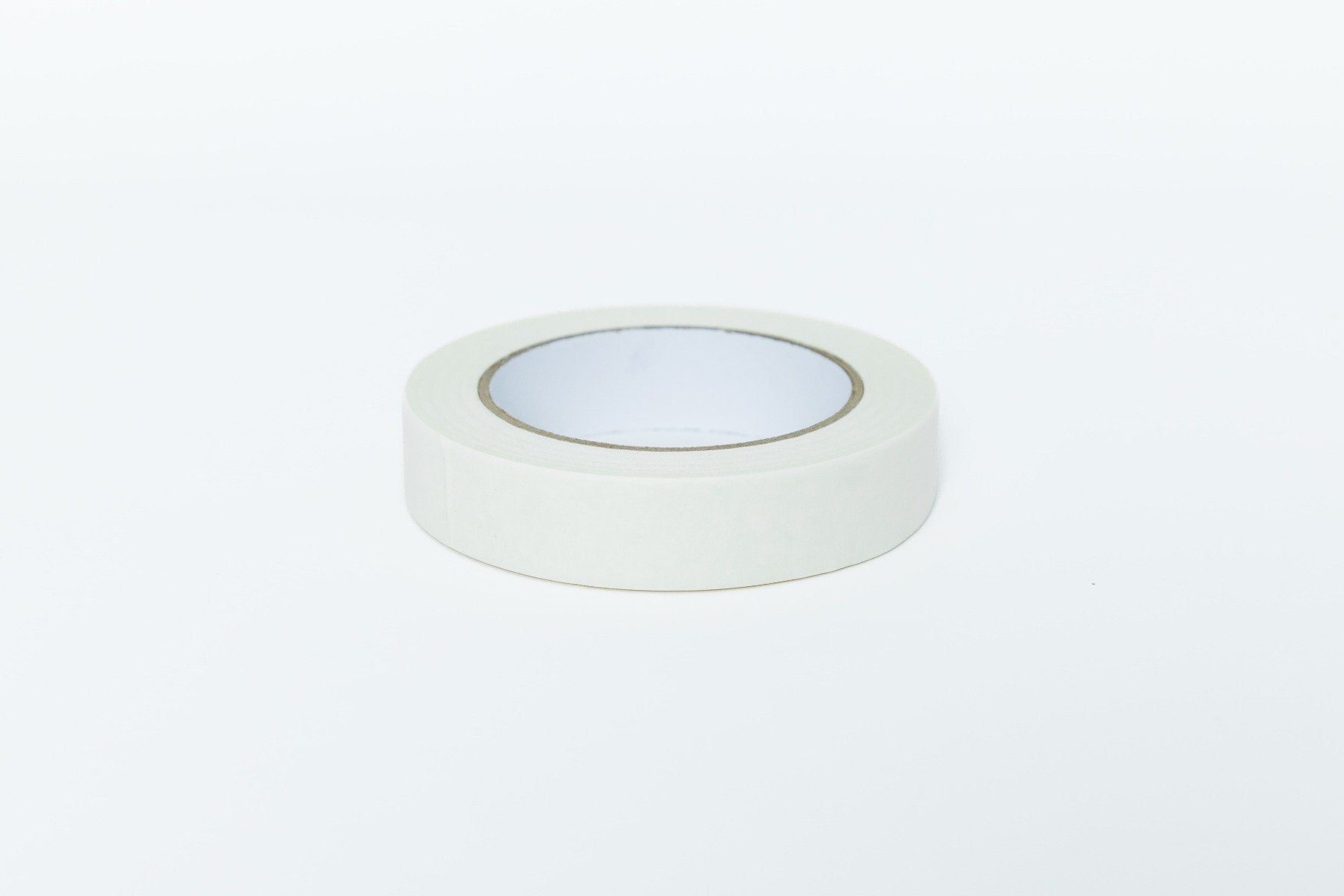 Roll of white tape on a light gray background