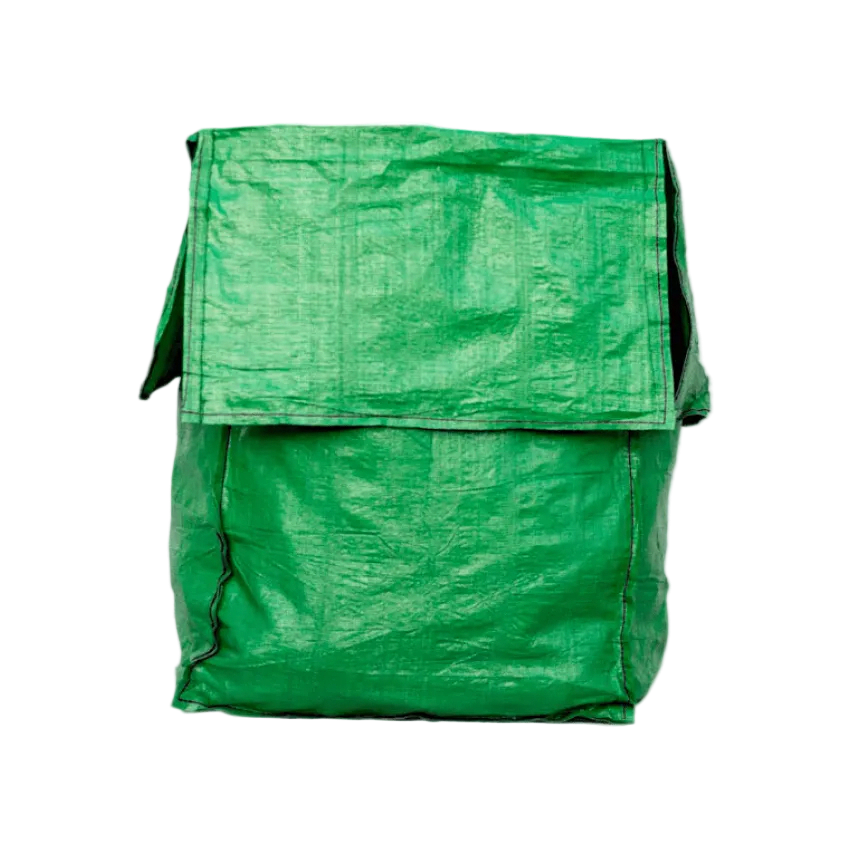 Garden waste bags and tools amidst lush greenery
