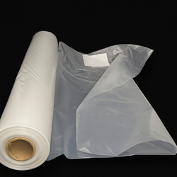 Roll of clear plastic sheeting on a black background