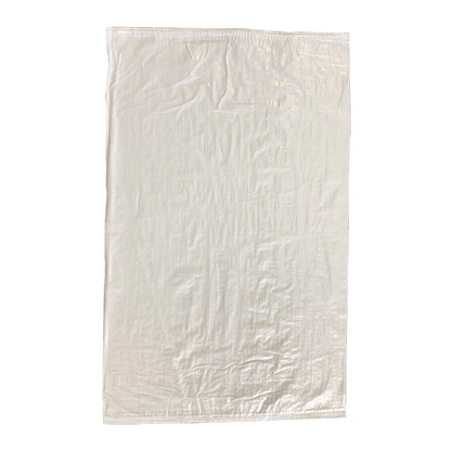 White woven polypropylene sack lying flat on green background, stitched hem, textured weave for rice or grain packaging