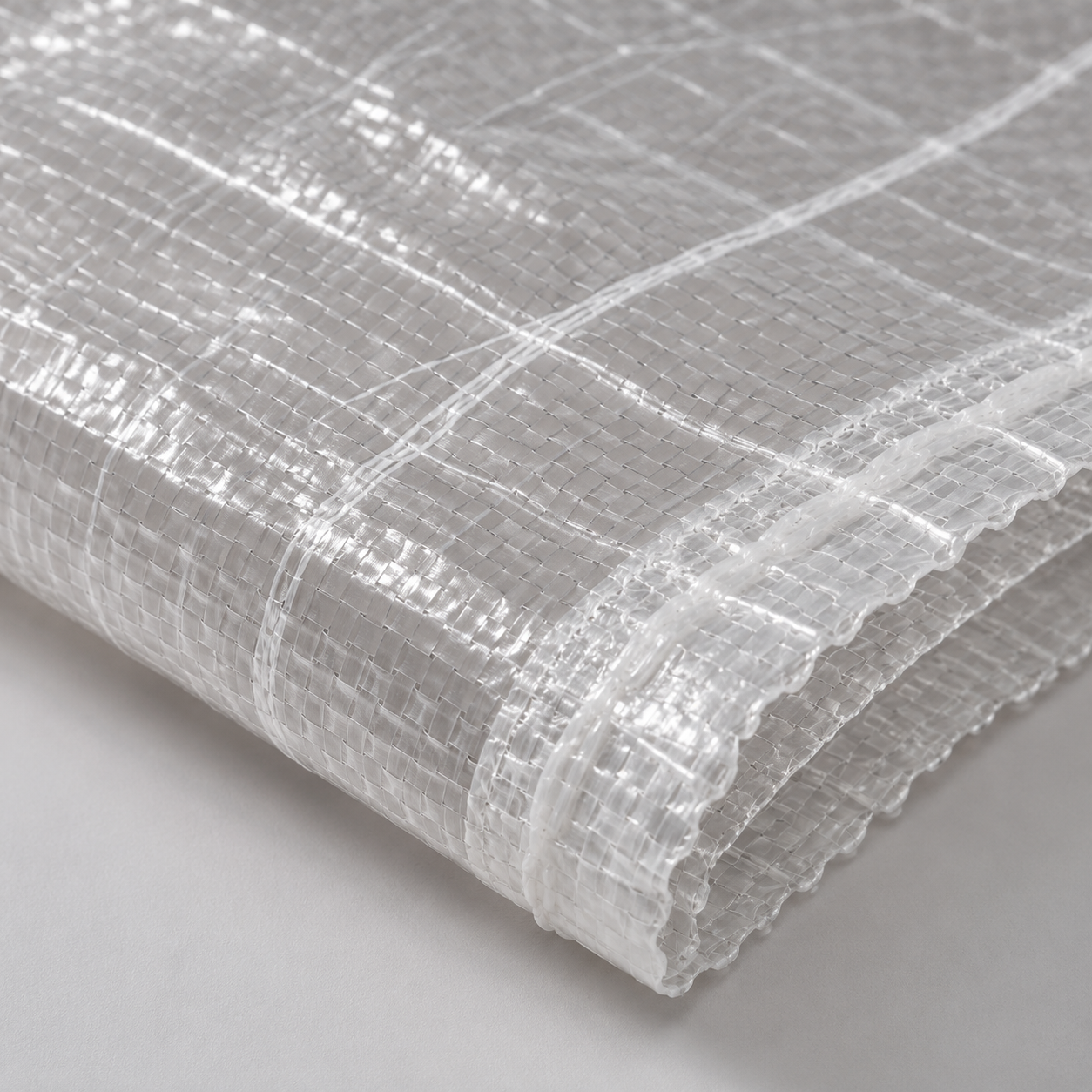 Close-up of transparent woven polypropylene bag showing mesh weave