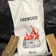 Firewood bag labeled 'FIREWOOD' with a log illustration and '20 KG' on a black background.