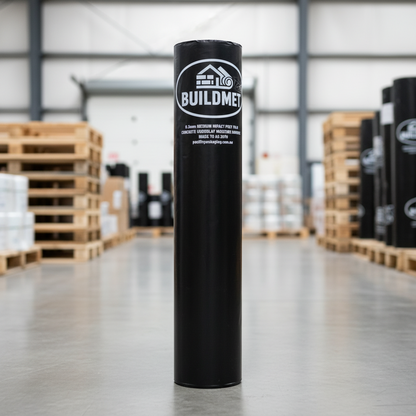 Black roll labeled BUILDMET standing upright on concrete warehouse floor between pallet stacks