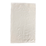 White woven polypropylene sack lying flat on green background