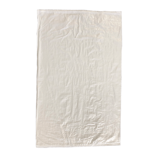 White woven polypropylene sack lying flat on green background